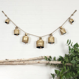  Bell garland hanging on white wall displaying full 53-inch width