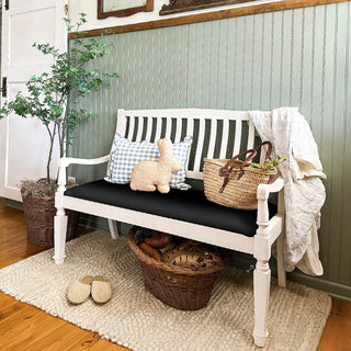 White farmhouse entryway bench with black seat cushion