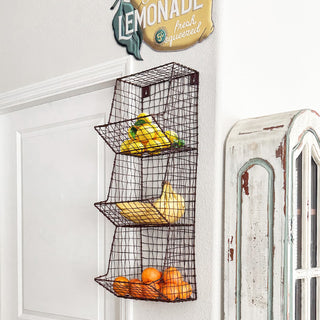 Hanging metal basket holding fruit in farmhouse kitchen