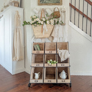 Farmhouse wood cubby organizer styled with baskets and florals