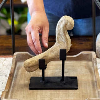 Person adjusting a 17th century stone bird temple fragment