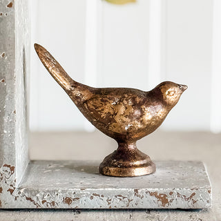 Close-up of gold cast iron bird figurine