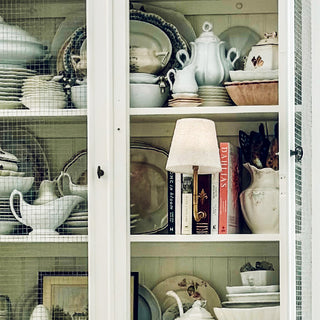 Farmhouse cabinet shelf with rustic accent lamp