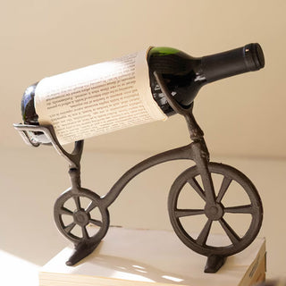 Decorative bicycle bottle holder displaying wine on styled surface

