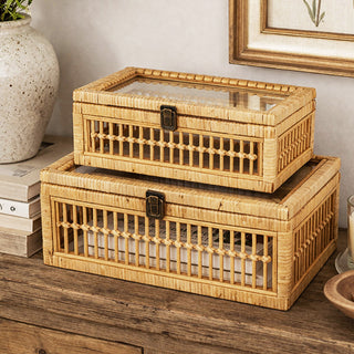  Medium and large decorative rattan boxes stacked on entryway table beside ceramic vase and framed prints
