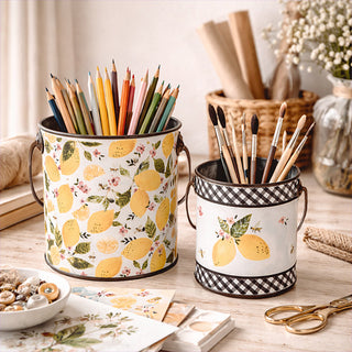 Set of two lemon print metal storage buckets with wooden handles on farmhouse desk
