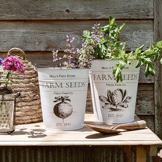Close-up of two white Farm Seeds buckets