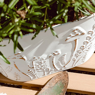 Decorative white planters styled on wooden garden bench