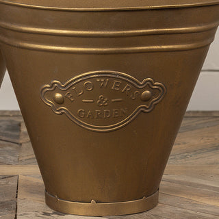  Set of two distressed gold Flowers and Garden wall bucket planters side by side on wood surface showing size difference