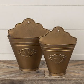  Set of two distressed gold Flowers and Garden wall bucket planters side by side on wood surface showing size difference