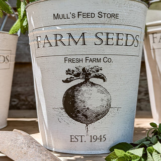 Close-up of white Farm Seeds metal bucket with vintage beet illustration