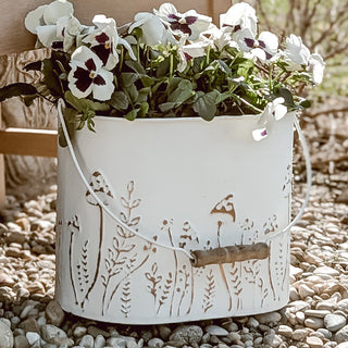 Decorative white planters styled on wooden garden bench