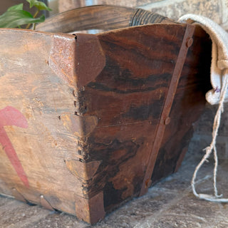 Corner detail of vintage wooden rice bucket with metal reinforcements and dovetail joints, authentic antique craftsmanship