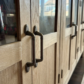 Metal cabinet hardware detail on wood sideboard buffet