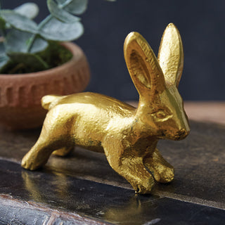 Close-up of distressed gold bunny figurine showing hammered texture detail