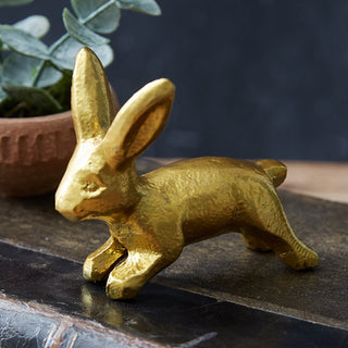Gold metal rabbit trio figurines styled with eucalyptus in modern farmhouse setting