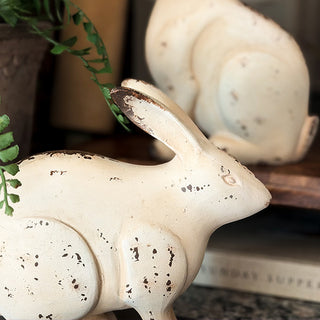 Cream resin bunny figurines with weathered patina finish