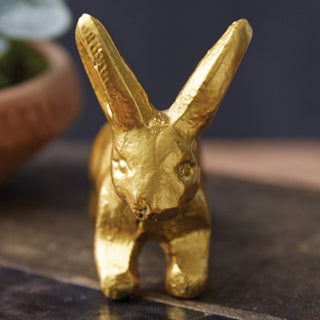 Gold metal rabbit trio figurines styled with eucalyptus in modern farmhouse setting