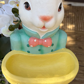 Yellow bowl Easter bunny statue close-up