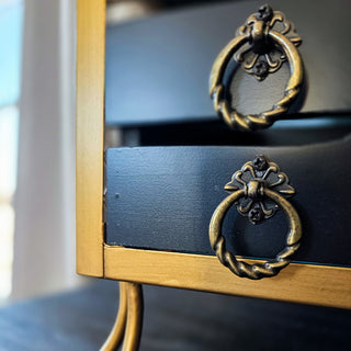 Antique brass ring pulls on navy drawer cabinet