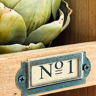 Detail of metal drawer pulls and card catalog hardware on vintage-inspired storage cabinet