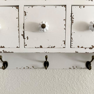 White ceramic drawer knob with antique brass center