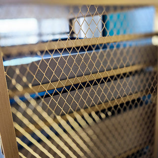 Gold mesh side detail on vintage drawer cabinet
