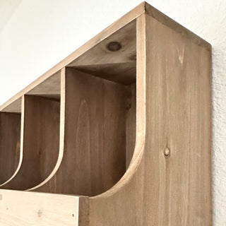 Detail view of rustic wooden cubby organizer showing smooth curved edges and natural wood texture.