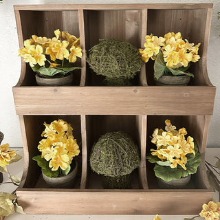 Rustic wooden cubby shelf styled with yellow floral arrangements and greenery for spring home décor