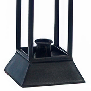 Close-up detail of weighted square pedestal base and taper candle holder on distressed black metal lantern