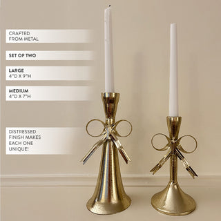Close-up detail of gold bow candle holder showing intricate ribbon sculpture and elegant metallic finish for romantic table centerpiece