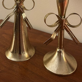  Gold bow taper candle holders styled on dining table with lit candles creating romantic ambiance for holiday entertaining and special occasions