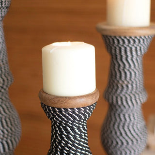 Close-up pillar candle on rope holder