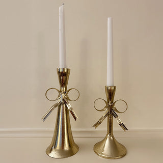 Side view of Victorian-style gold metal bow candle holder showing weighted base and standard taper opening for wedding and Christmas decor