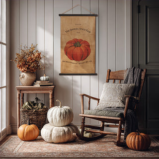 Rustic farmhouse fall décor with Annual State Fair pumpkin canvas wall art, rocking chair, stacked pumpkins, and cozy autumn accents