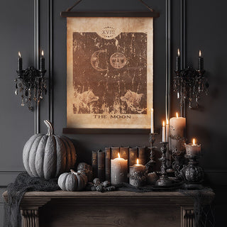 Vintage “The Moon” tarot wall canvas styled above gothic mantel with candles, pumpkins, and dark Halloween décor