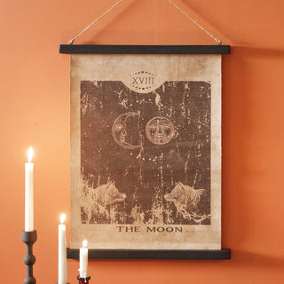 Howling Moon tarot canvas wall art hanging on burnt orange wall with candles and rustic Halloween décor