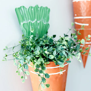 Carrot shaped metal wall planter close up