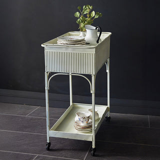Farmhouse metal serving cart with two shelves and rolling wheels, antique white finish with corrugated panel