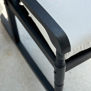 Single black porch rocking chair with garden view