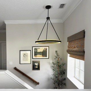 Contemporary staircase with round LED pendant chandelier