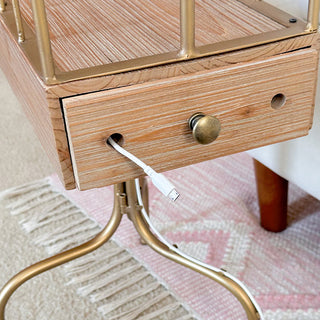 chairside table with phone charging port and brass hardware detail
