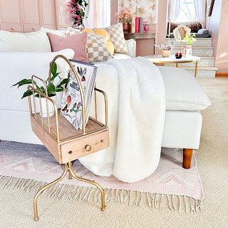 multi-functional side table holding books plants and devices in modern living room
