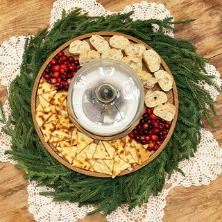 Round wood serving tray with cloche and appetizers