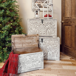 Carved wooden storage chests with holiday décor