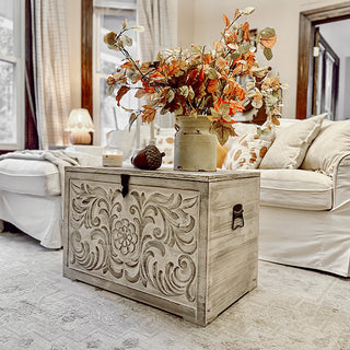 Carved wood chest styled with fall floral arrangement