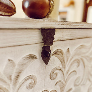 Close-up of carved wood chest metal latch