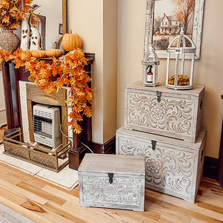 Decorative wood chests displayed by fall fireplace décor