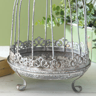 Distressed metal birdcage base with ornate detailing