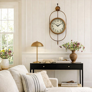 Kensington Station London vintage oval wall clock with distressed bronze gold finish in elegant living room above console table